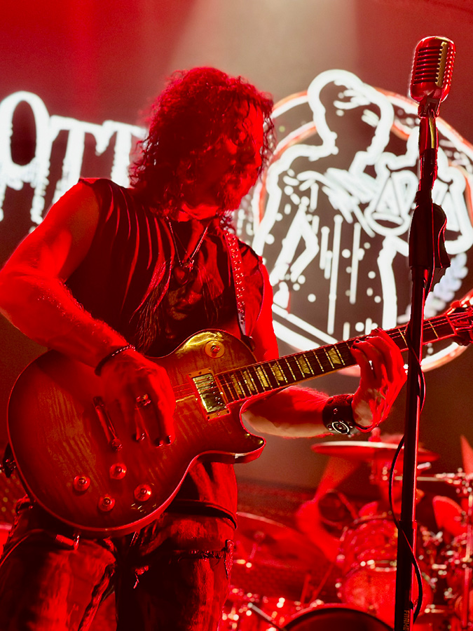 Mike Ruggirello playing a Gibson Les Paul at a Rotten Cabal show Music Box with Red Light